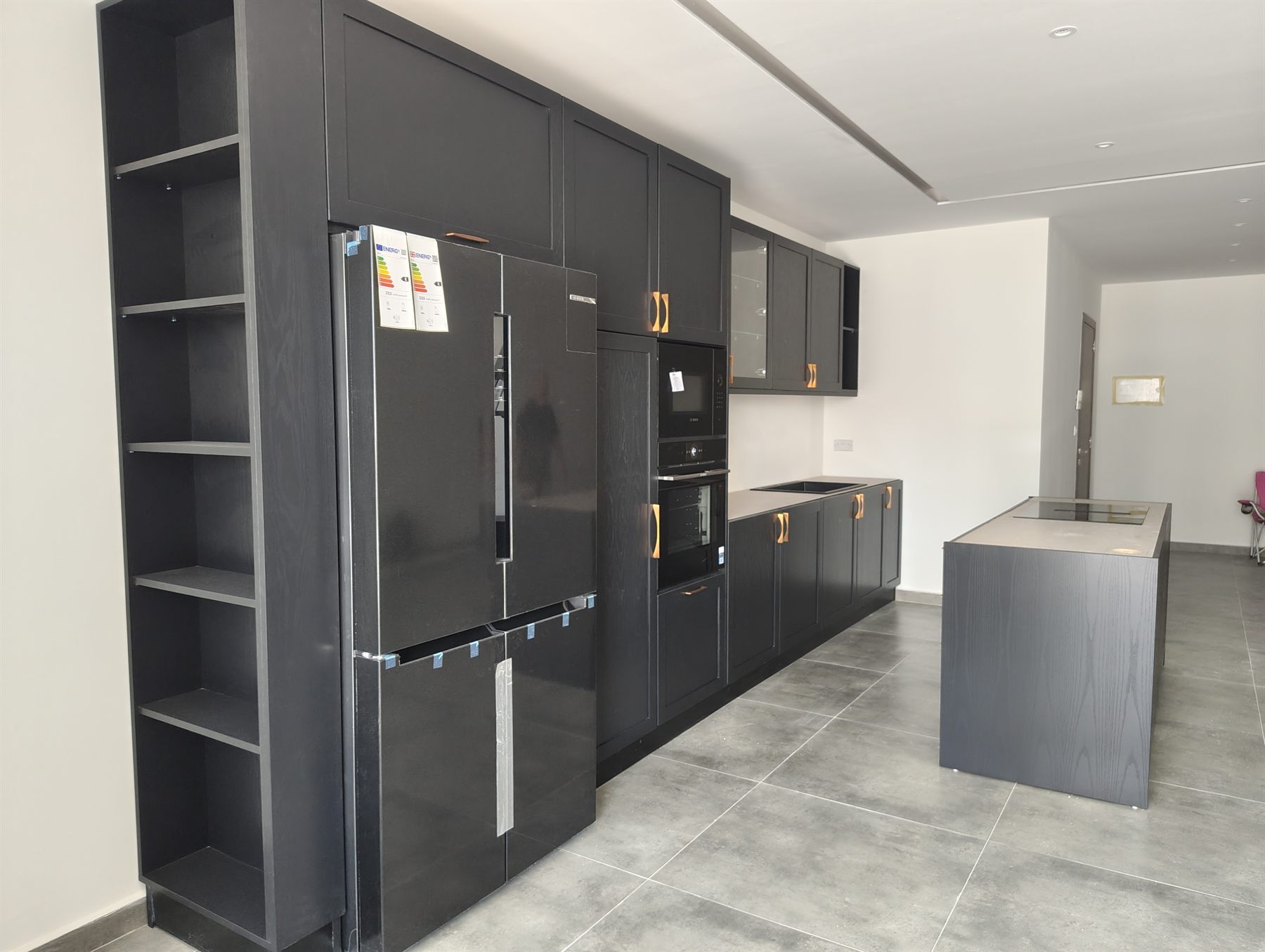 Black fitted kitchen with copper handles