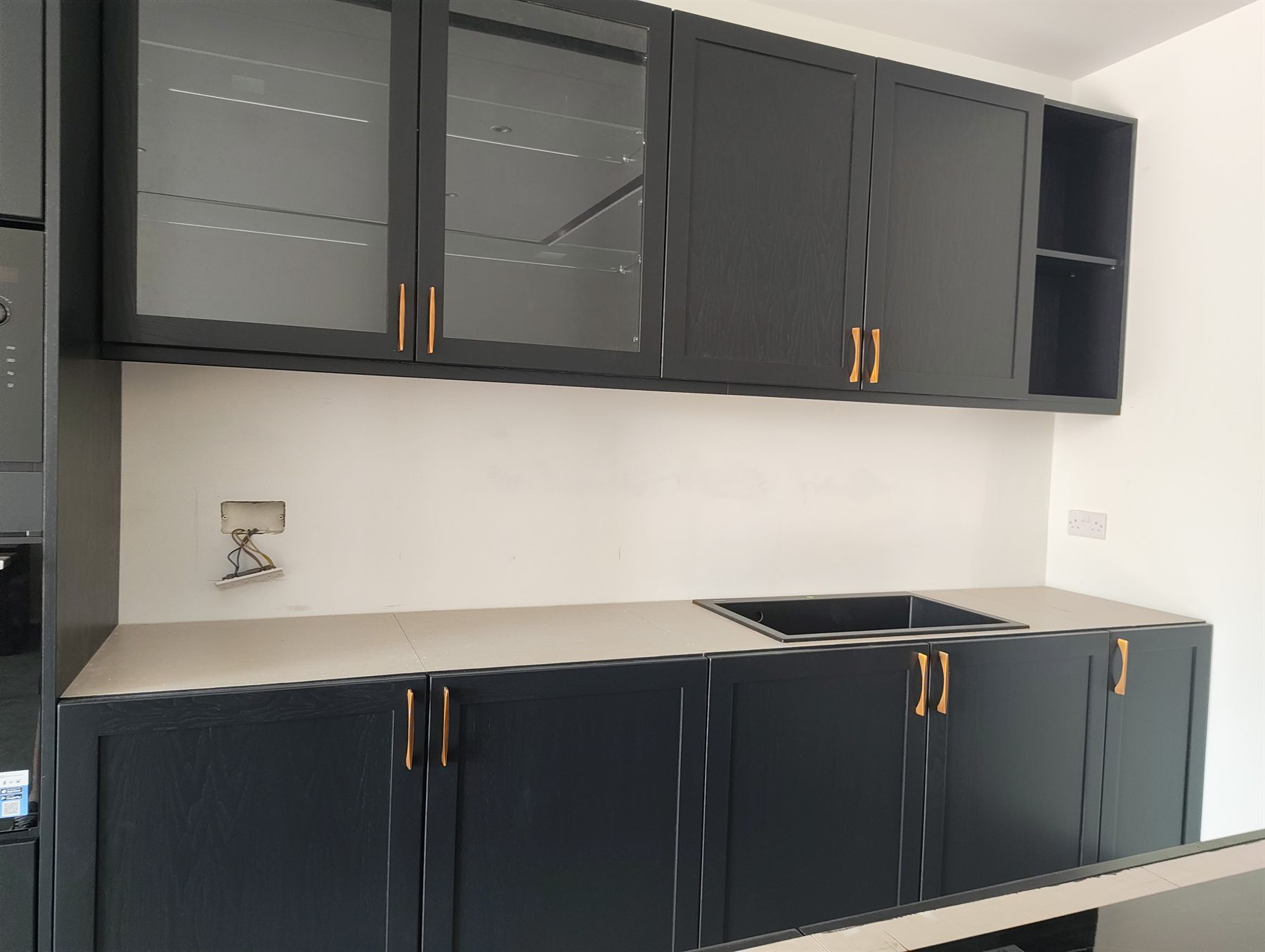 Black kitchen units with pull-out larder