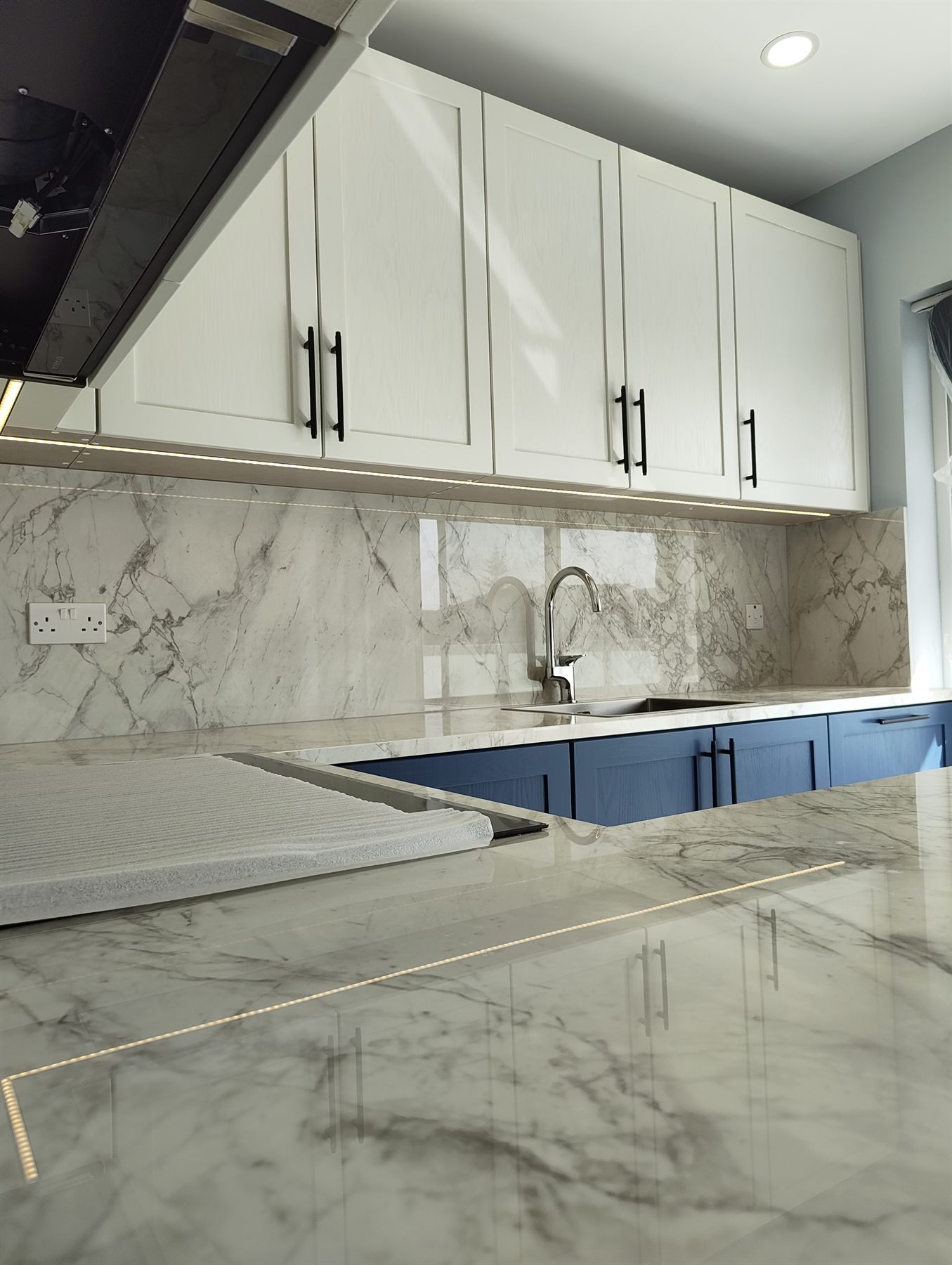 Navy blue kitchen with tall larder units