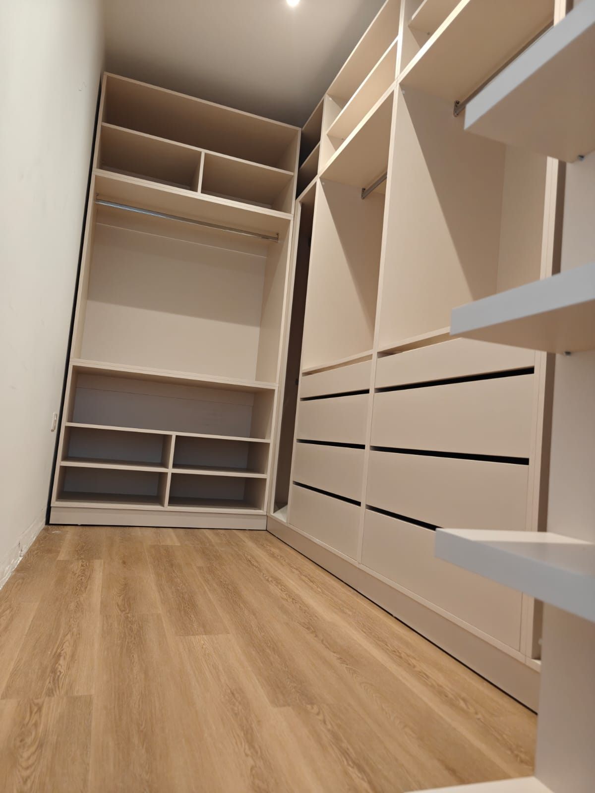 Walk-in wardrobe with fitted drawers and hanging space