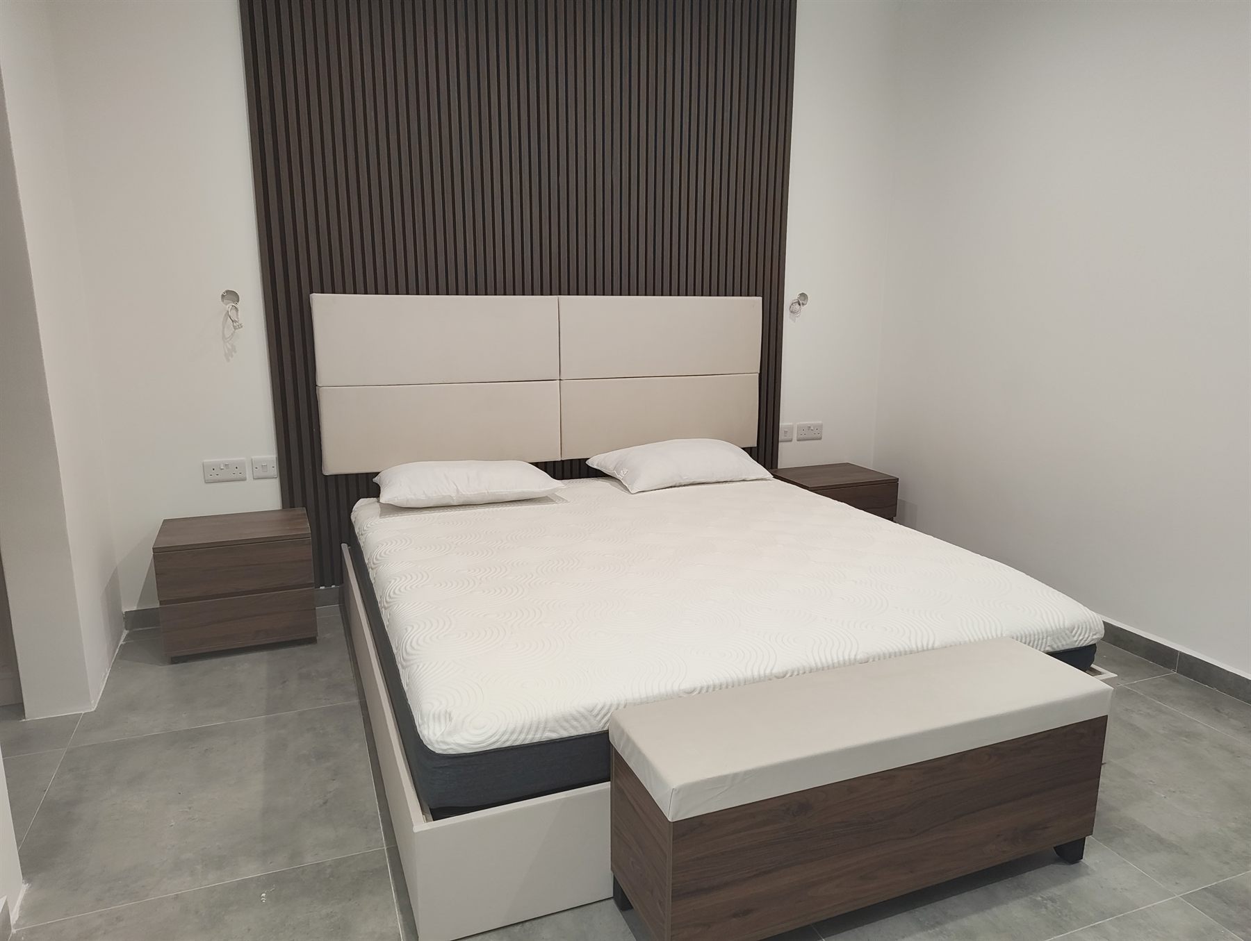 Bedroom with slatted walnut feature wall