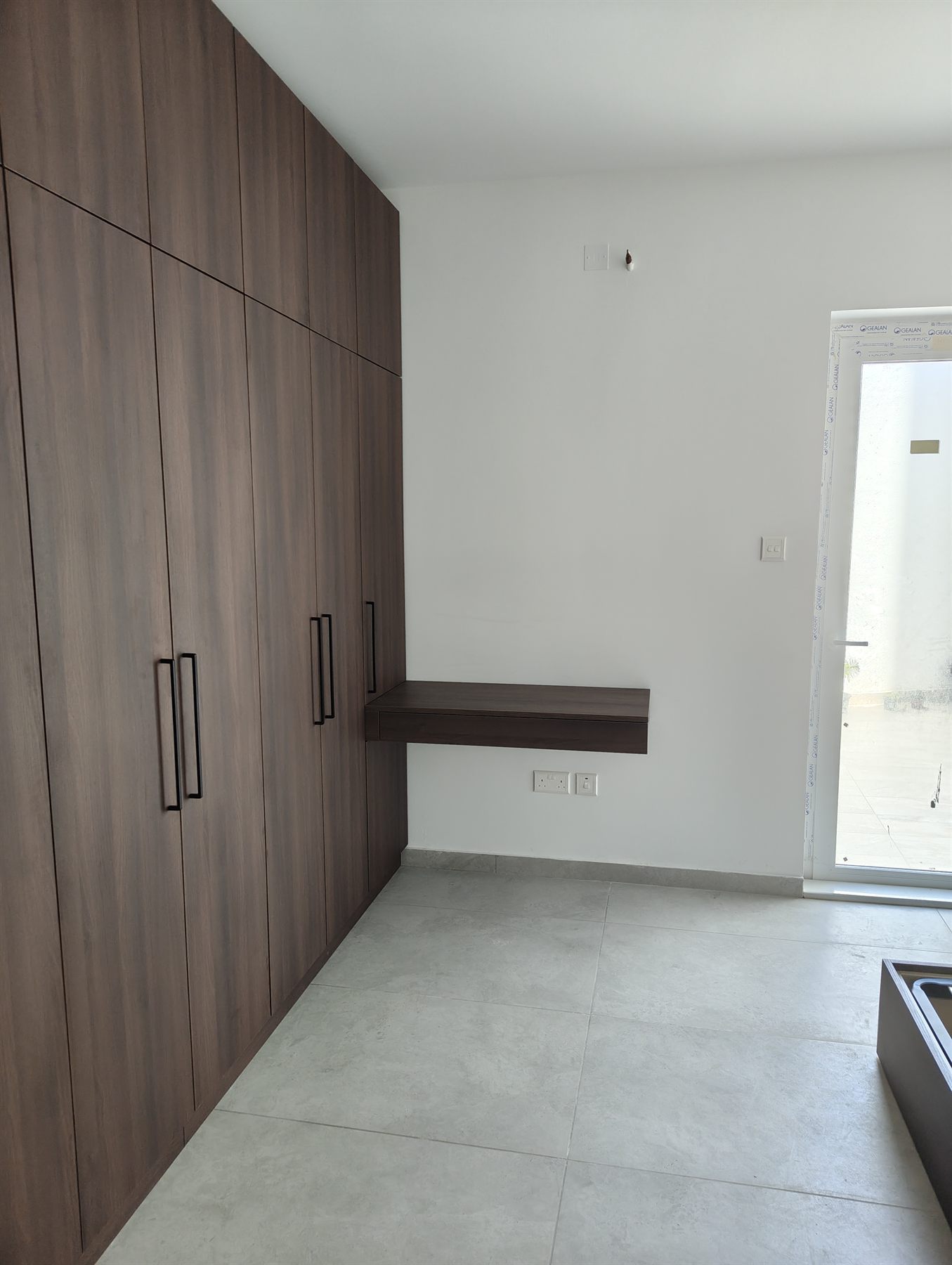 Walnut fitted wardrobes with floating desk